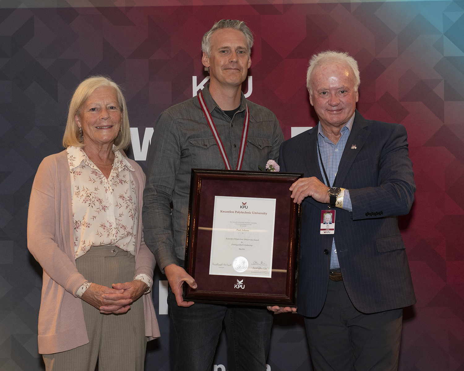 Dr. Paul Adams, centre, receives his Distinguished Scholarship Award from Dr. Deborah Henderson, Director of the Institute for Sustainable Horticulture, and Dr. Alan Davis, KPU President and Vice-Chancellor.